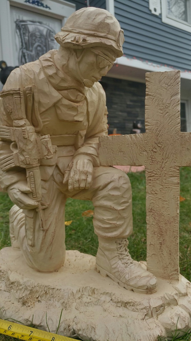 Soldier Kneeling At Cross Statue